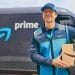 Repartidor de Amazon Prime sosteniendo un paquete frente a una furgoneta con logo de Prime. Imagen usada en Mundo Chido para ilustrar los beneficios de Amazon Prime.